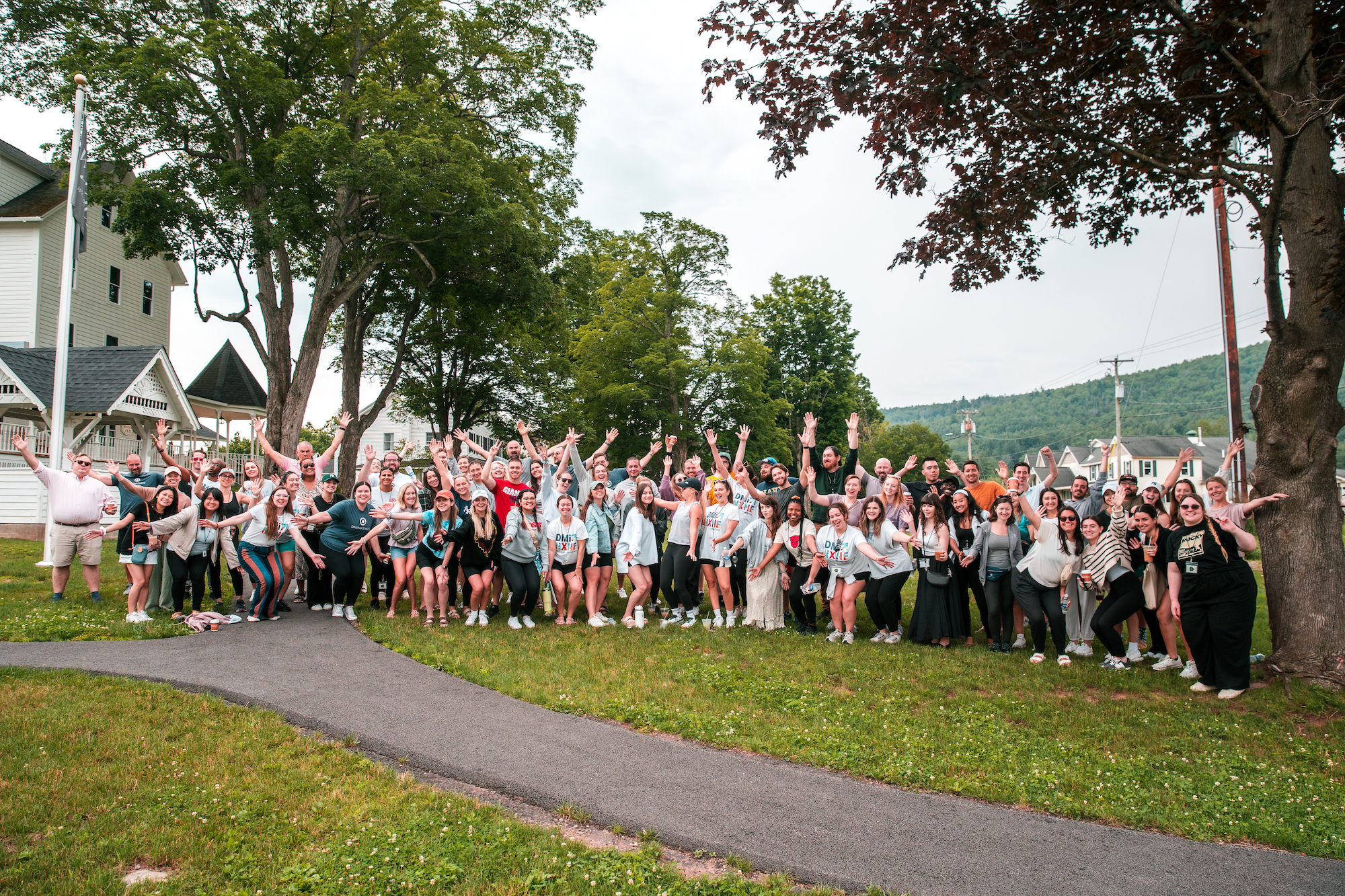 A large group of people are smiling for their corporate retreat photo